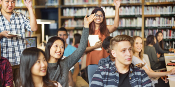 Students Attentively Listening To Female Teacher In The Classroom.