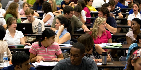 Teenage Students In College Discussing About Their Academics.