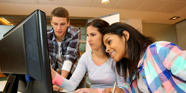 Group of College Students Studying Through Computer.