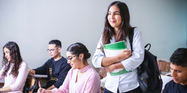A Female Student Standing In The Class.