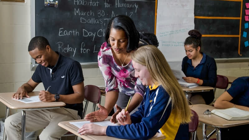 A Teacher Teaching A Teenage Girl In The Classroom.